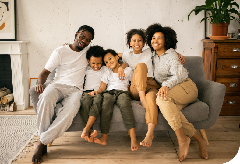 foster family with two children sitting on couch